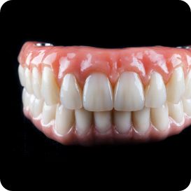Hand holding a model of an implant denture